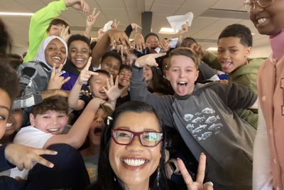 Thuba and a group of students in a selfie, smiling and throwing peace signs